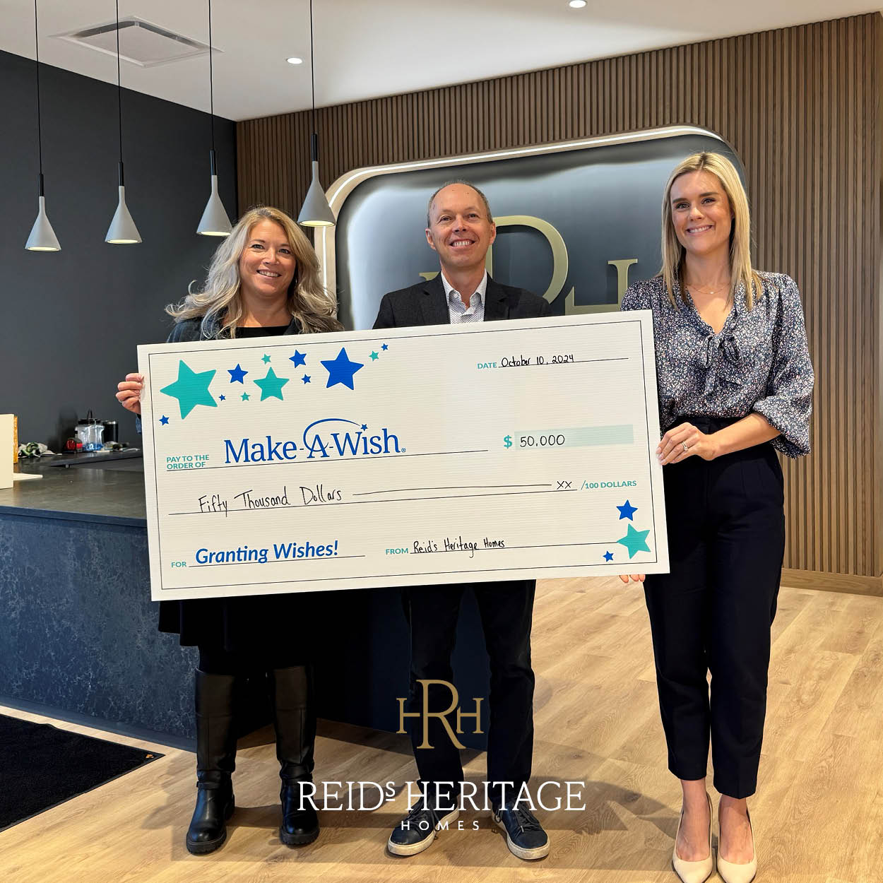 Stephanie Grondinger, Ron McMillan and Jennifer Muller with the $50,000 donation cheque for the Make-A-Wish foundation